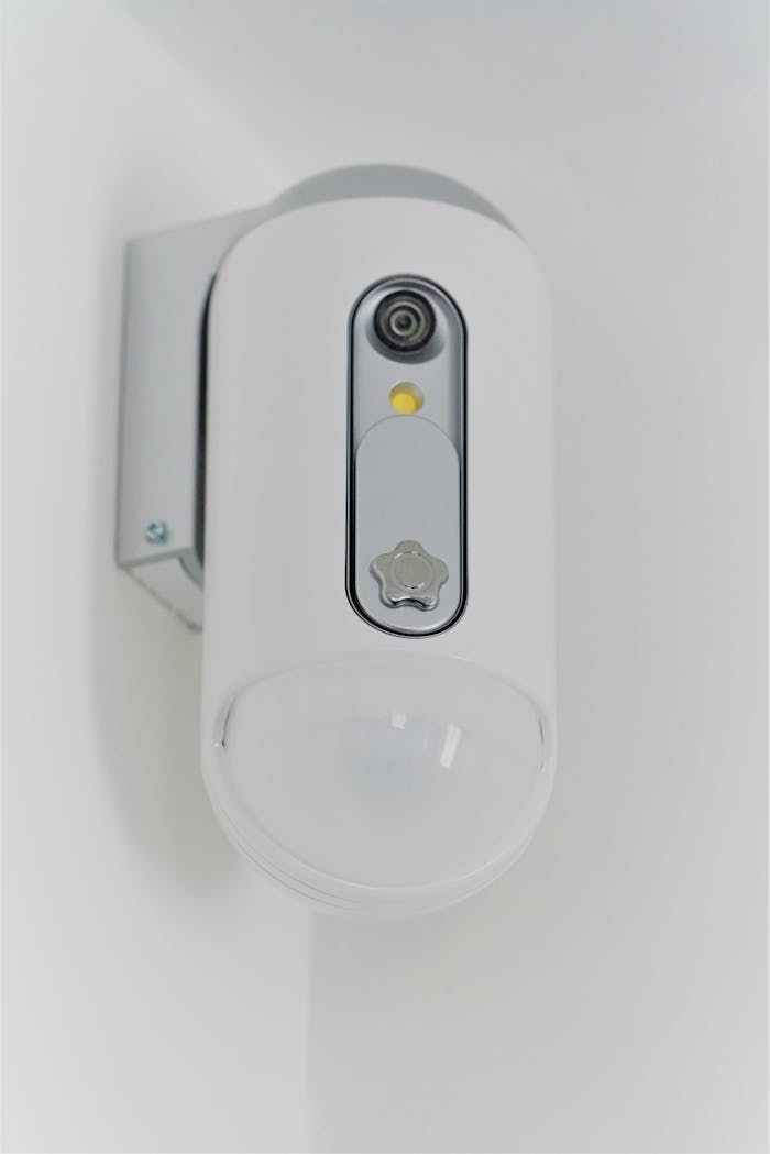 Close-up view of a contemporary indoor surveillance camera mounted on a wall for security monitoring.